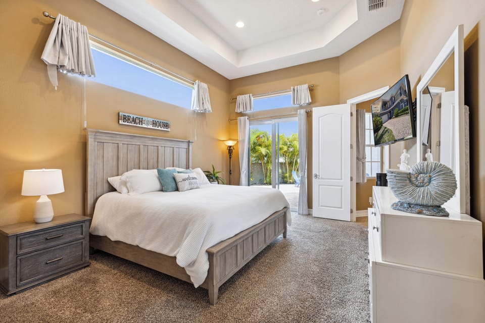 Master bedroom with a king-size bed and sliding doors leading straight to the backyard oasis!