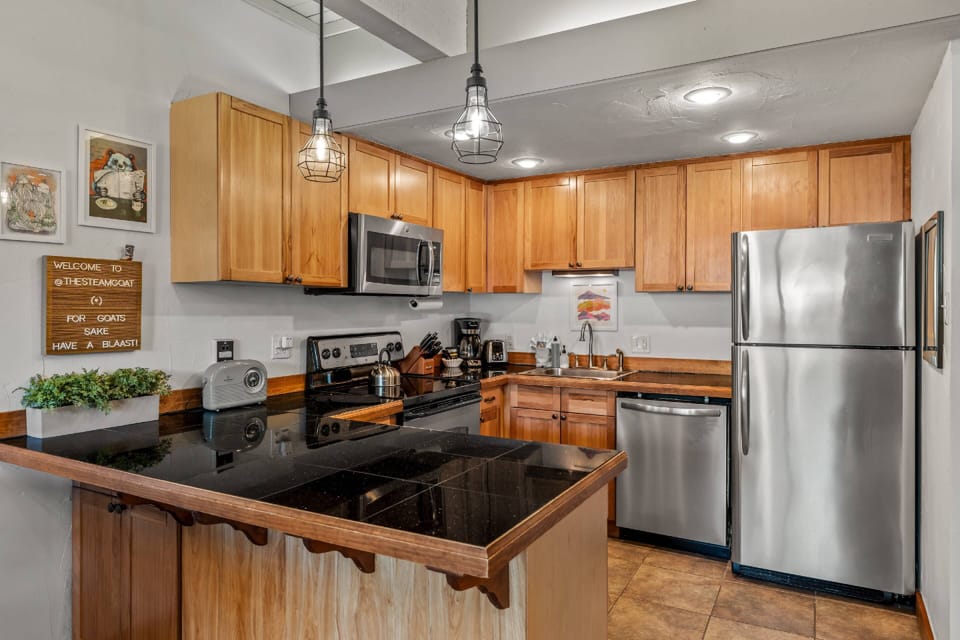 Cook comfortably in this spacious, open-concept kitchen with generous counter space and inviting mountain-home design.