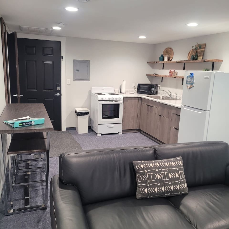 Toaster oven, hot plate, coffee pot, frig, microwave, wine opener, pizza cutter, dishes, silverware, coffee cups, etc. 