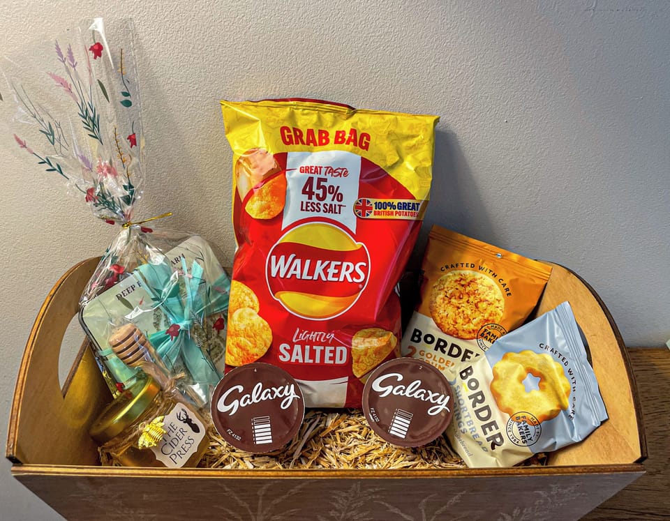 Guest Welcome basket, hot chocolate, biscuits, potato crisps, local honey and a souvenir gift