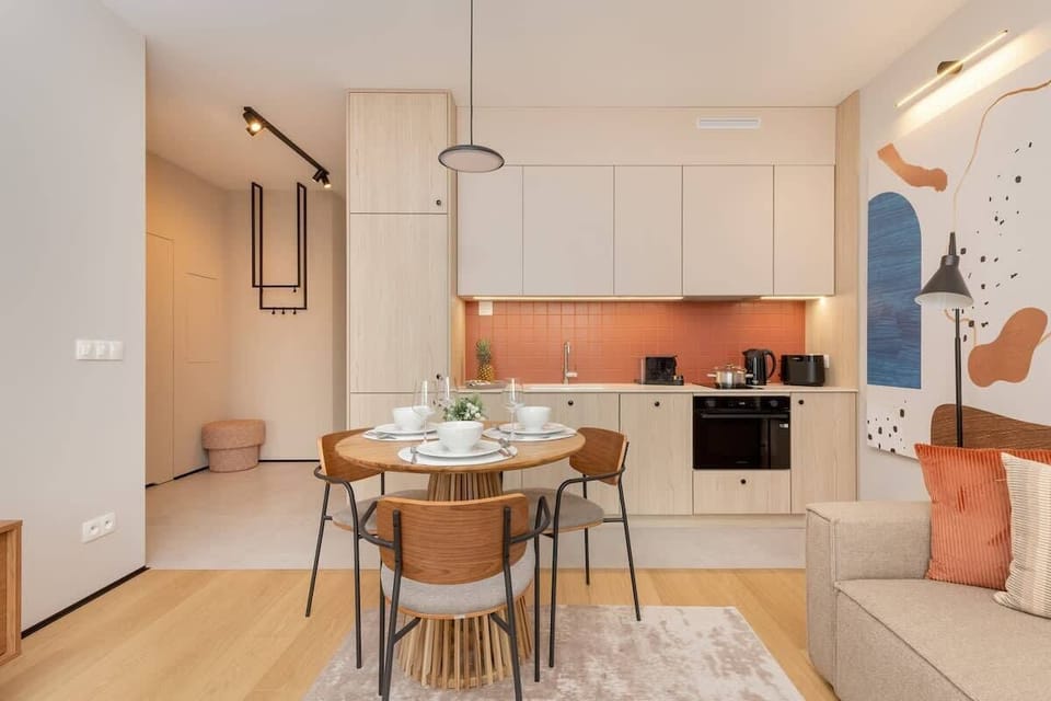  Elegant dining area with a round table and modern chairs, perfect for meals with loved ones.