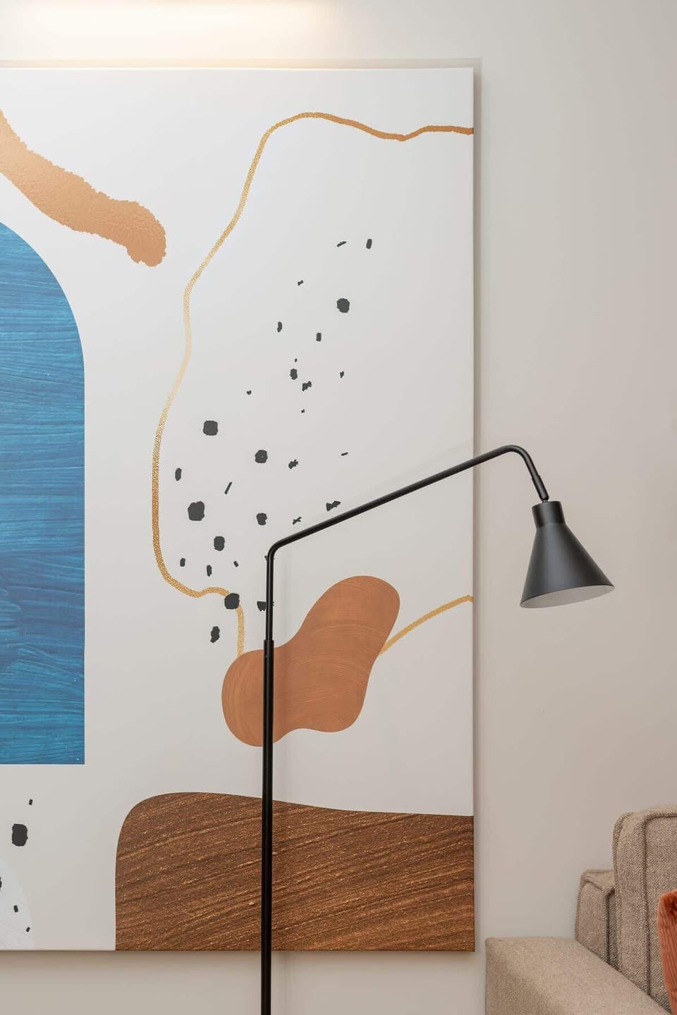 Modern living room with a designer floor lamp, elegant colors, and original decor, adding character to the space.