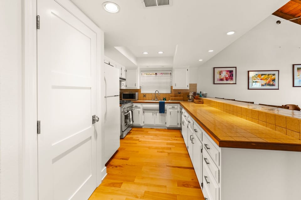 Kitchen is equipped with cooking basics and appliances. 