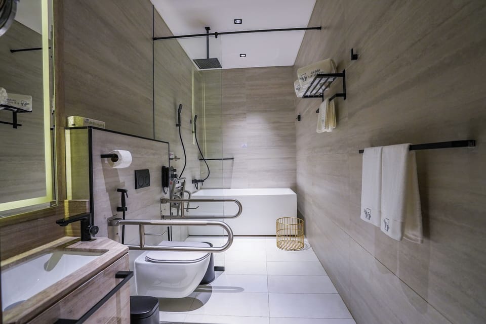 Suite- Disability Access | Bathroom | Combined shower/tub, hair dryer, slippers, bidet