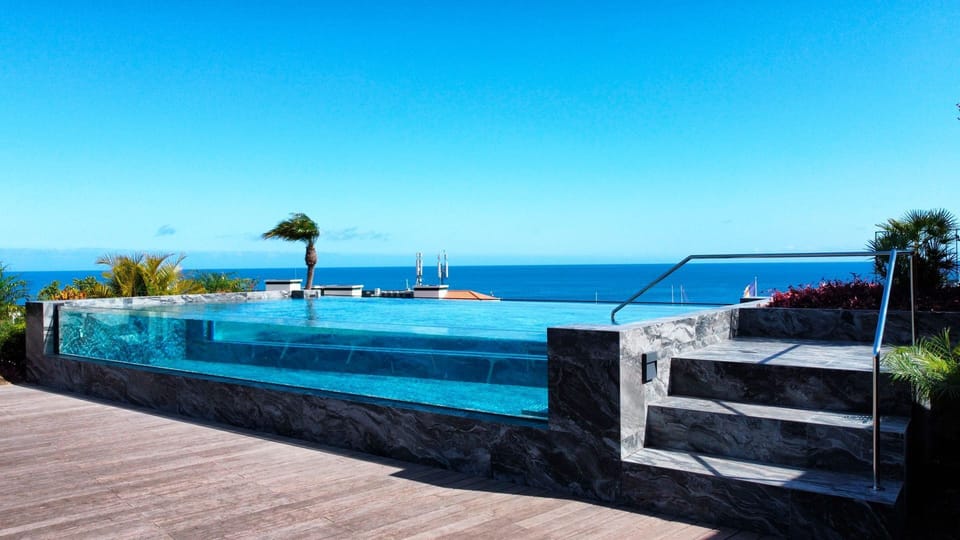 Relax in the infinity pool with stunning panoramas of Funchal city and the vast expanse of the ocean. #glasspool #oceanview