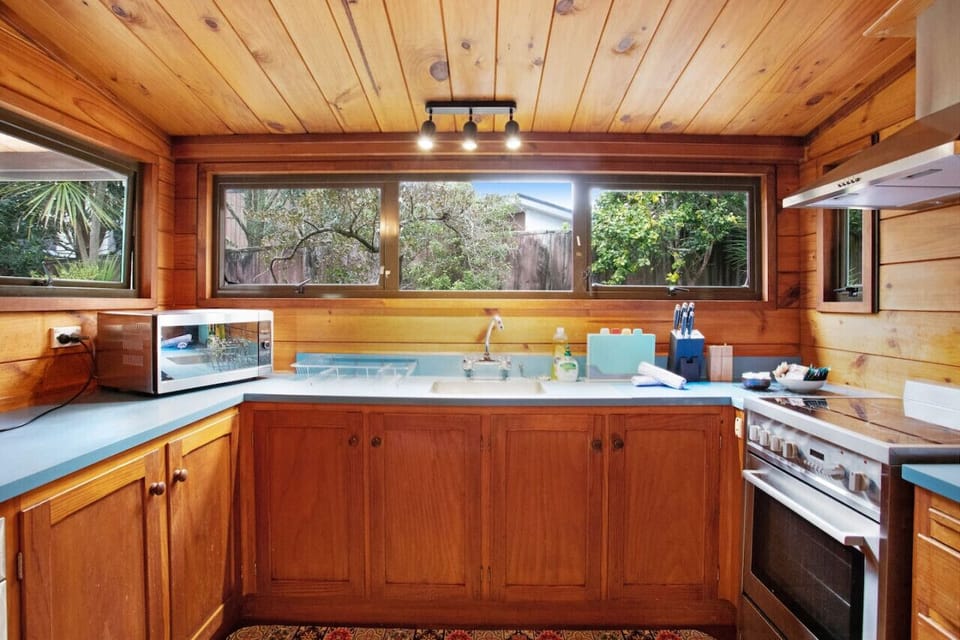 The kitchen has a microwave, cooktop, oven, and dishwasher.