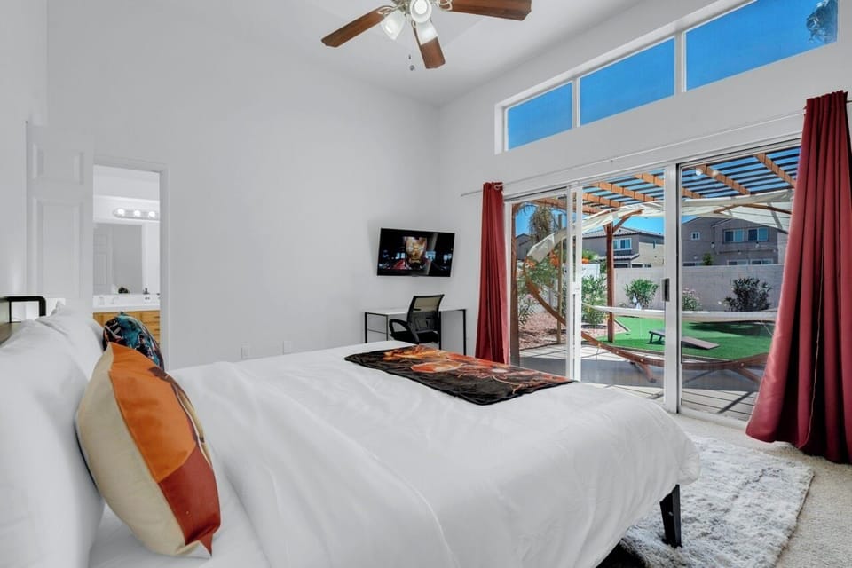 Iron Man-themed master bedroom with king bed, bath,office space, backyard access