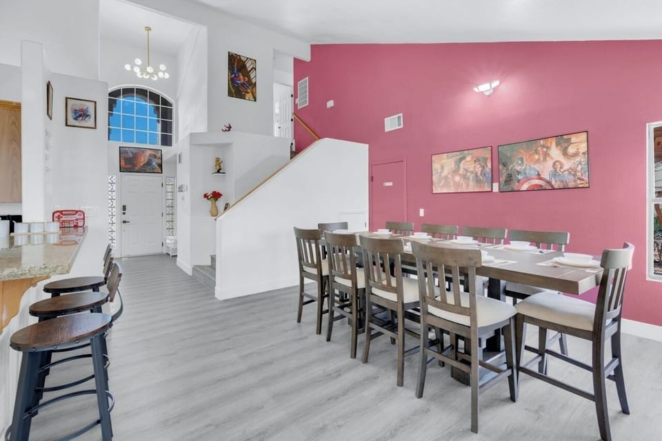 10-seat table, high ceiling, daylit, open access to kitchen and backyard