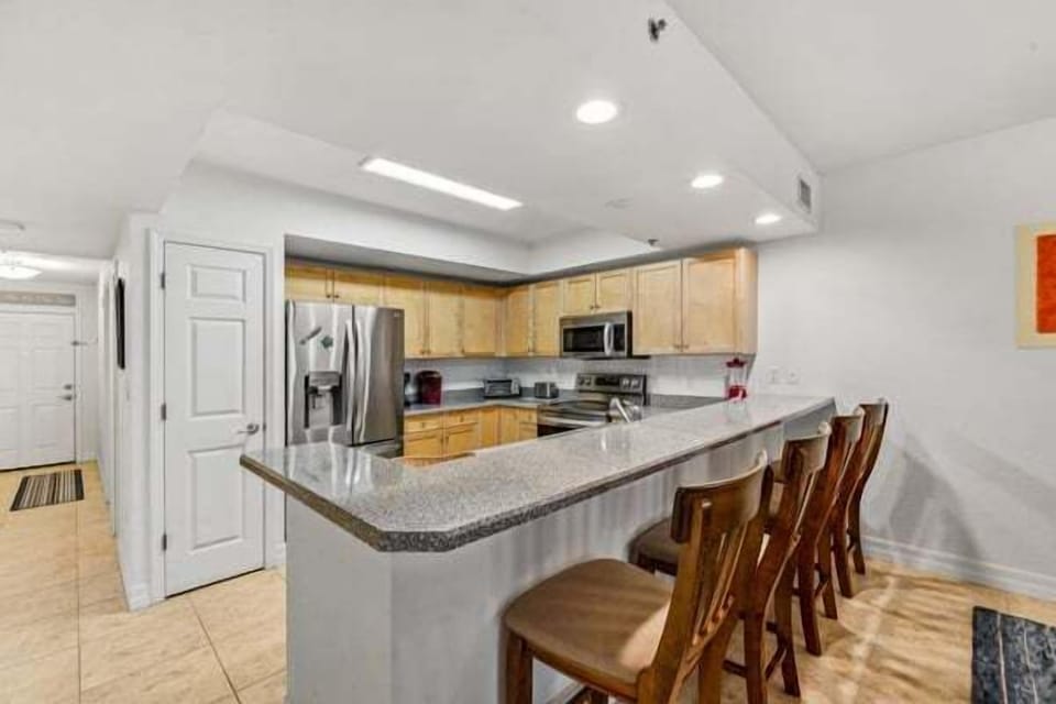 A bright and functional kitchen with plenty of seating, perfect for gathering, dining, and entertaining
