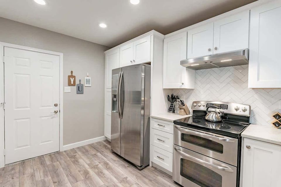 Kitchen with white cabinets, upgraded countertops, stainless steal appliances , coffee maker and cooking items to be able to cook and entertain. 