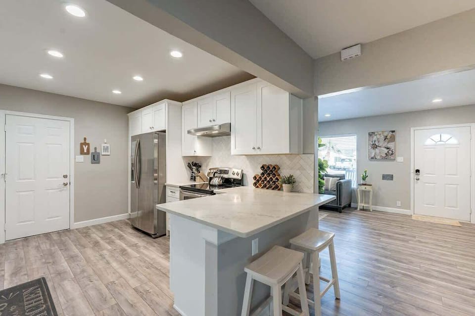 Kitchen with Island for additional seating and just next to the 2nd living space that features a game room. 