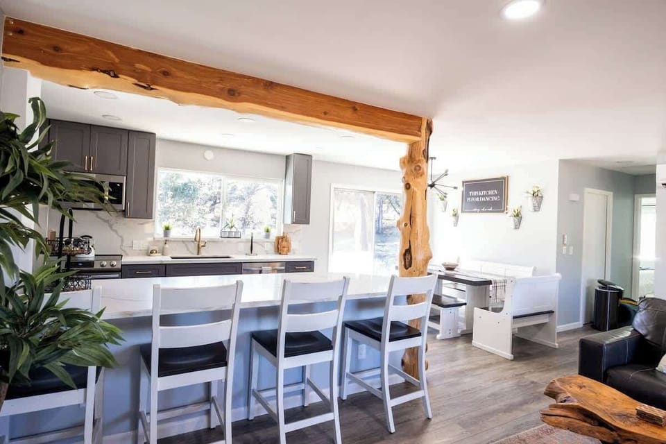 Large open concept kitchen and dining with extra chairs and the kitchen Island. 