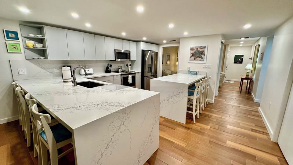 The beautifully appointed kitchen has seating for 7.