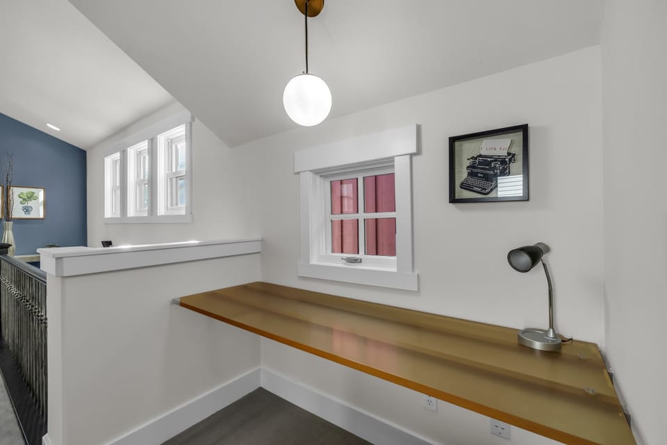 Living room 2: 3-person couch, reading chair, TV, workspace, laundry closet, upper floor