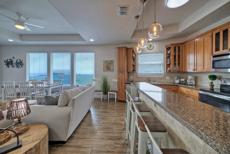 Kitchen features a counter with barstool seating.