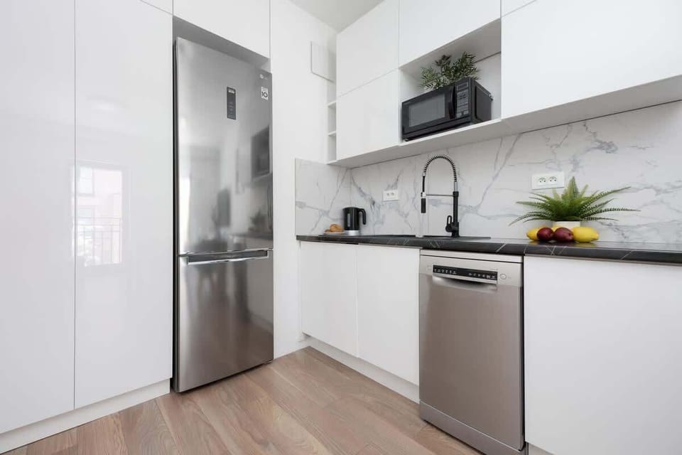 Bright kitchen with cooking utensils. 