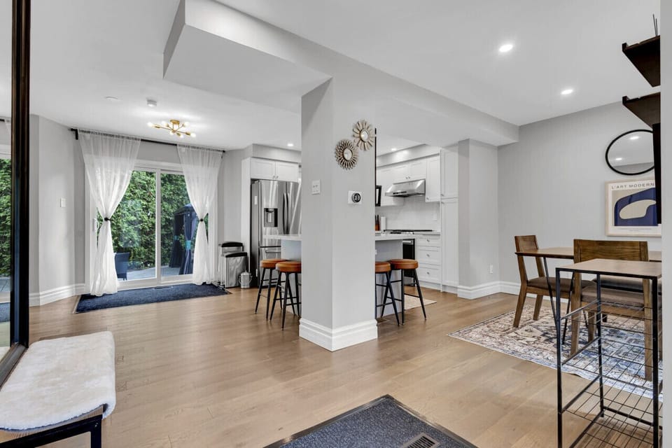 Well-lit dining room with contemporary design and window views.