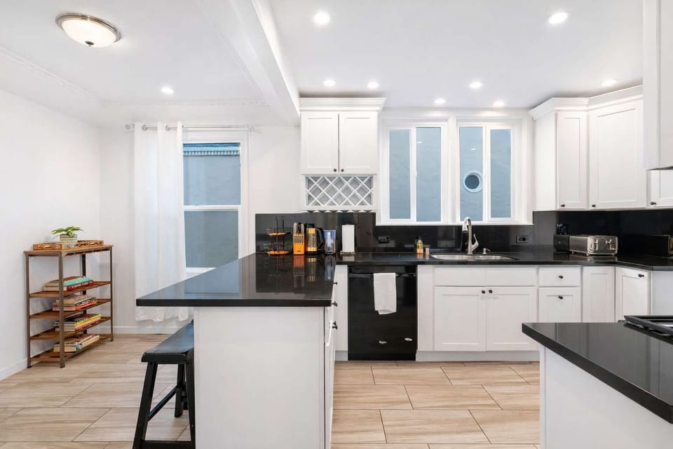 Bright and spacious kitchen with modern appliances, large island seating, and plenty of counter space—perfect for cooking, dining, and gathering together.