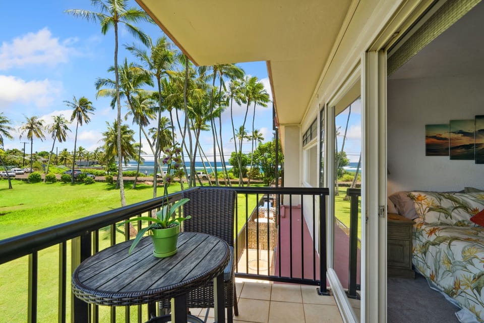 The second lanai from the bedroom opens directly to this! Ocean views, tropical grounds, and a lanai table for two. Morning coffee just became the best part of the day.