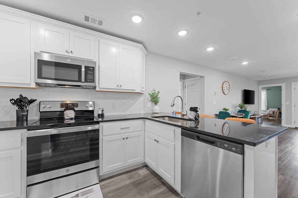 Featuring modern appliances, including a microwave, stove, and dishwasher.