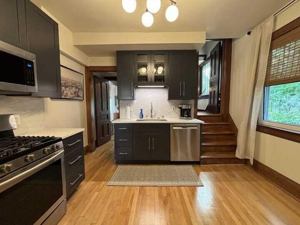 Modern, fully equipped kitchen with stainless steel appliances & sleek cabinetry