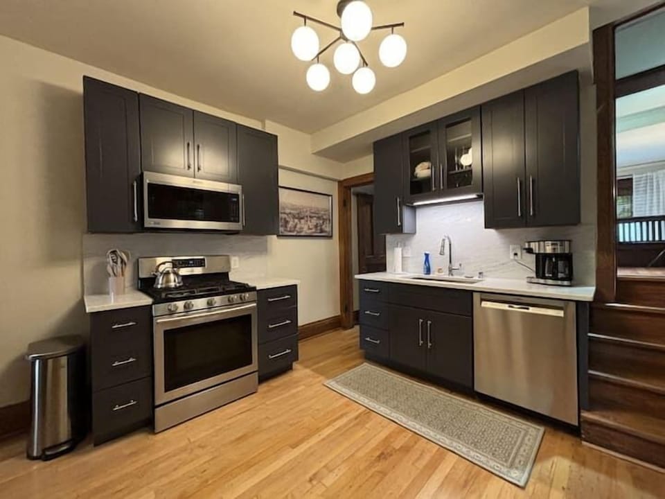 Modern, fully equipped kitchen with stainless steel appliances & sleek cabinetry