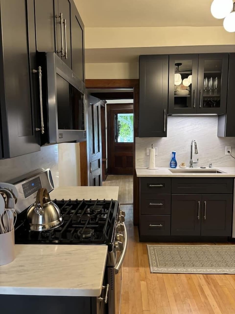Modern, fully equipped kitchen with stainless steel appliances & sleek cabinetry