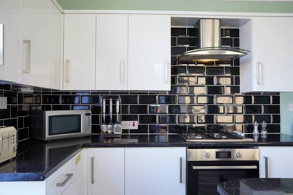 Features sleek cabinetry, pendant lighting, and a stylish backsplash, perfect for cooking and entertaining.