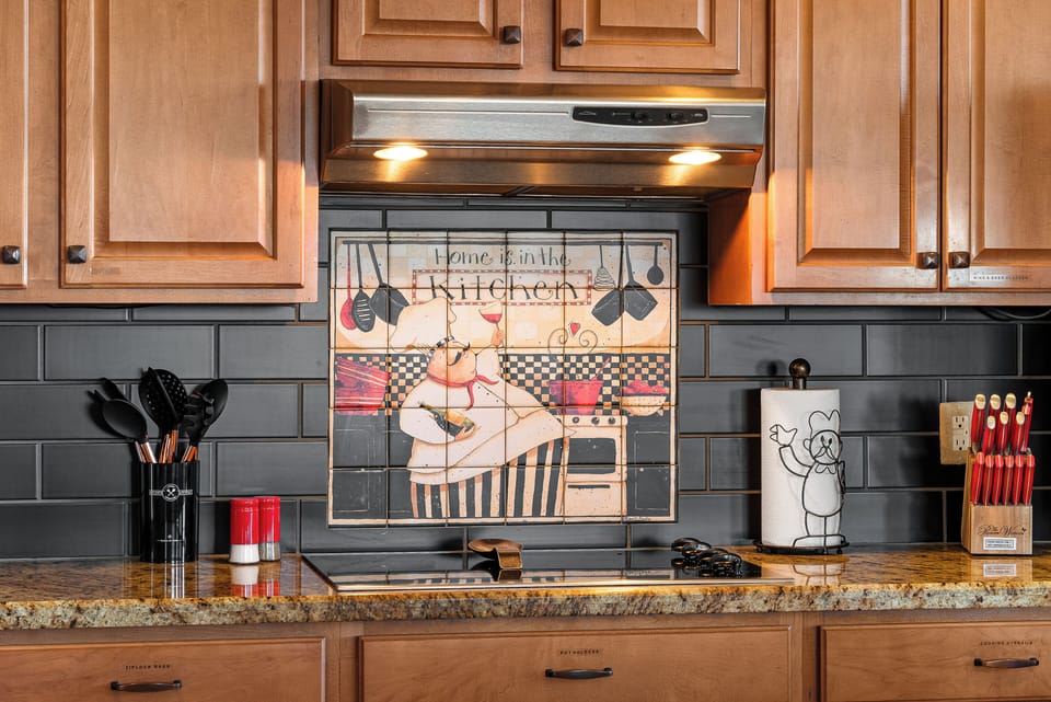 Custom signed back splash in main kitchen