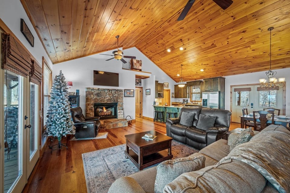 A cozy, light-filled living room centered around a warm gas fireplace—perfect for relaxing nights in.
