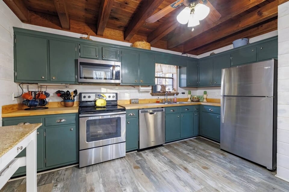 Fully equipped kitchen with modern appliances and ample prep space.