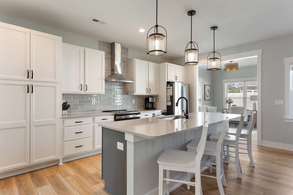 The tastefully modern fully stocked Kitchen with sleek countertops, new appliances (2024), and contemporary furnishings is perfect for whipping up a culinary masterpiece that is sure to impress!
