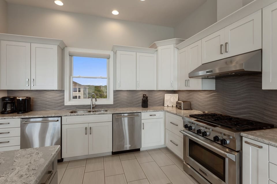 Whip up something delicious in the Kitchen with 2 Full-Size Refrigerators, 2 Dishwashers, 2 Ovens, and a Range with a Hood to create the perfect vacation dining experience!