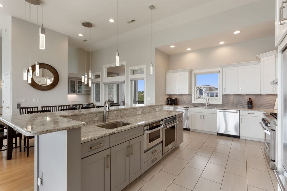 Whip up something delicious in the Kitchen with 2 Full-Size Refrigerators, 2 Dishwashers, 2 Ovens, and a Range with a Hood to create the perfect vacation dining experience!