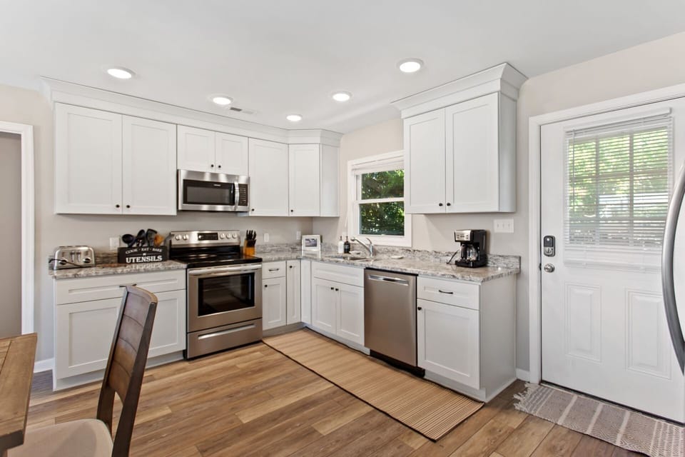 The kitchen with modern appliances is the perfect spot to whip up something delicious for the whole family to enjoy.
