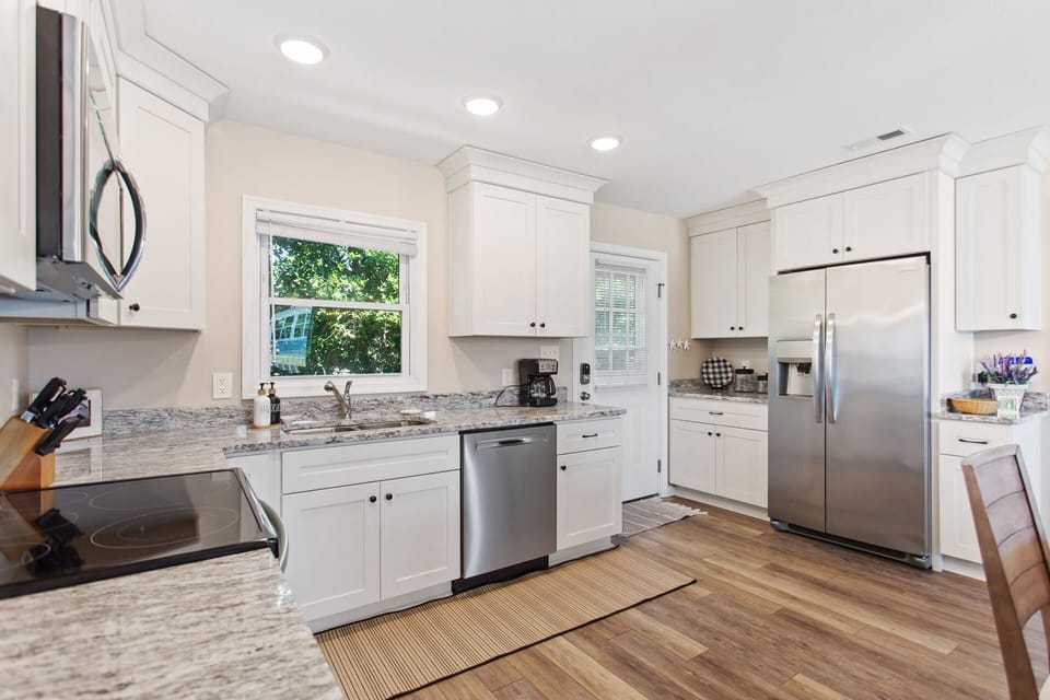 The kitchen with modern appliances is the perfect spot to whip up something delicious for the whole family to enjoy.