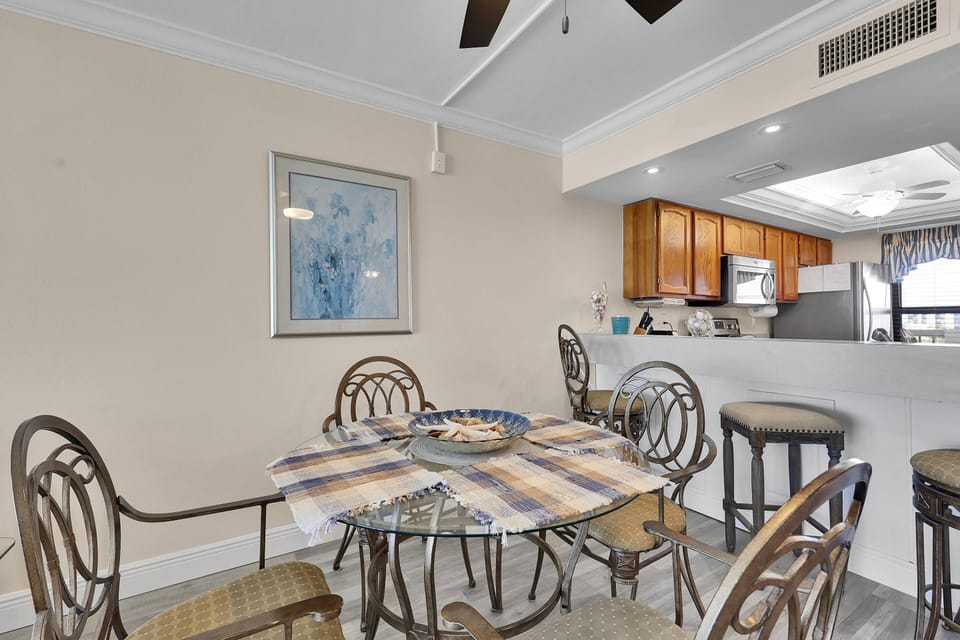 An eating bar with bar stools separates the kitchen from the dining area.