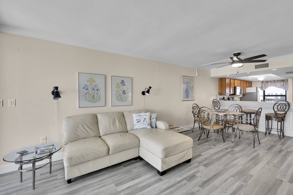 Back inside, a dining area with seating for 4 sits between the living room and kitchen.