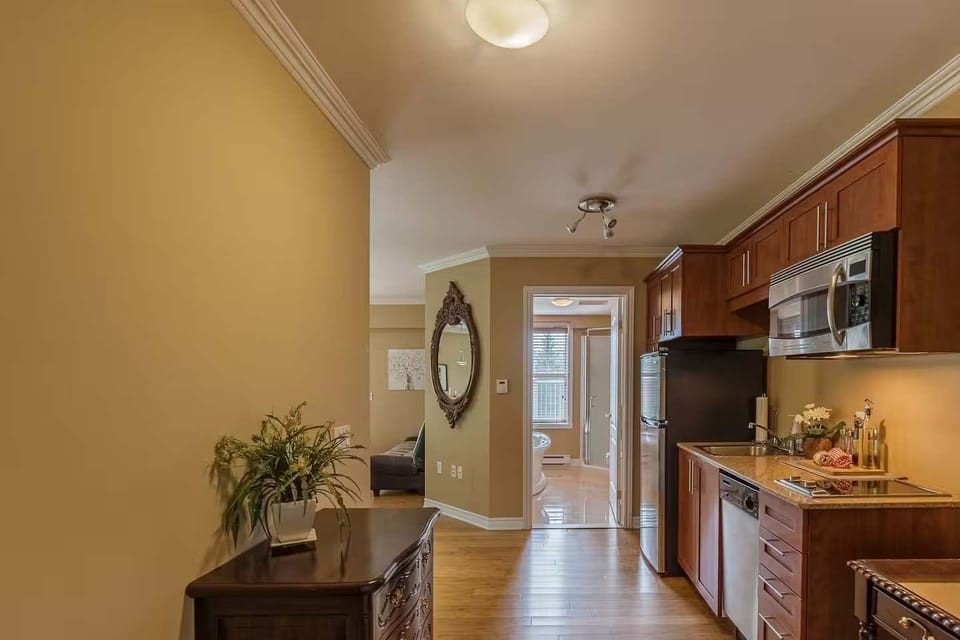 Cozy hallway leading to the kitchen with warm lighting and tasteful decor