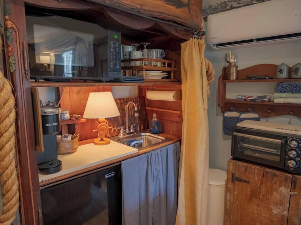 In the private living room is a kitchenette area for heating up something quick. 