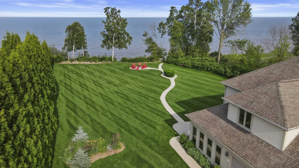 Ariel shot facing East. Tall trees divide lots, creating privacy to your own secluded oasis. The sunrise comes over the water every morning, an absolutely stunning experience.