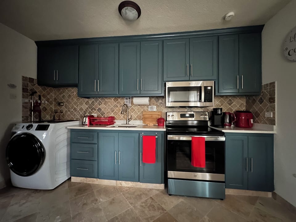 Kitchen outfitted with GE appliances (fridge, microwave, stove & washer).