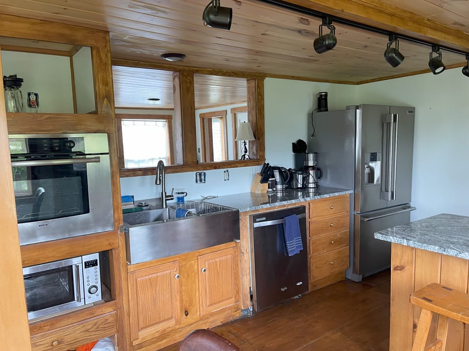 Kitchen. Windows look into living room.