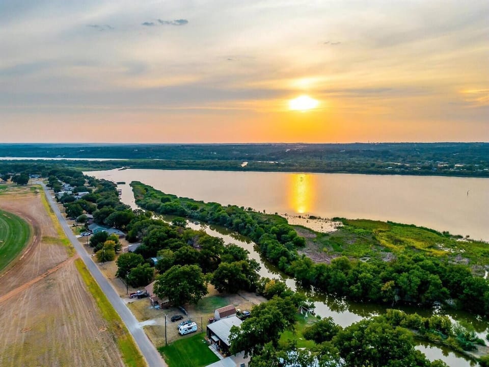 Aerial sunset view of La Vie Lake Retreat on Lake Granbury, Texas.


