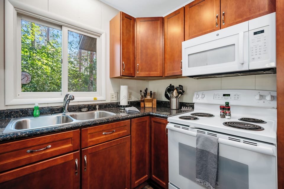 Cook with ease in the bright kitchen featuring granite counters & a window over the sink.