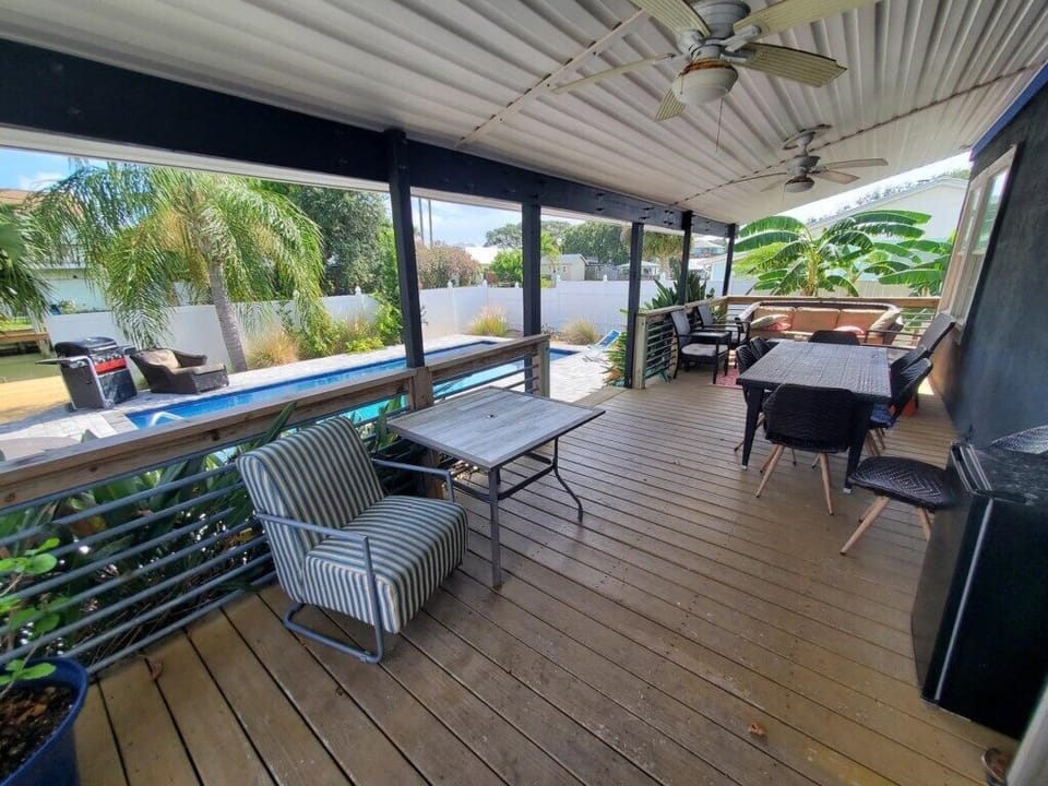Spacious covered patio with dining set and comfortable seating.