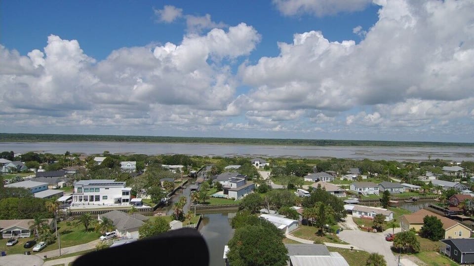 Aerial view of coastal neighborhood with expansive water views.