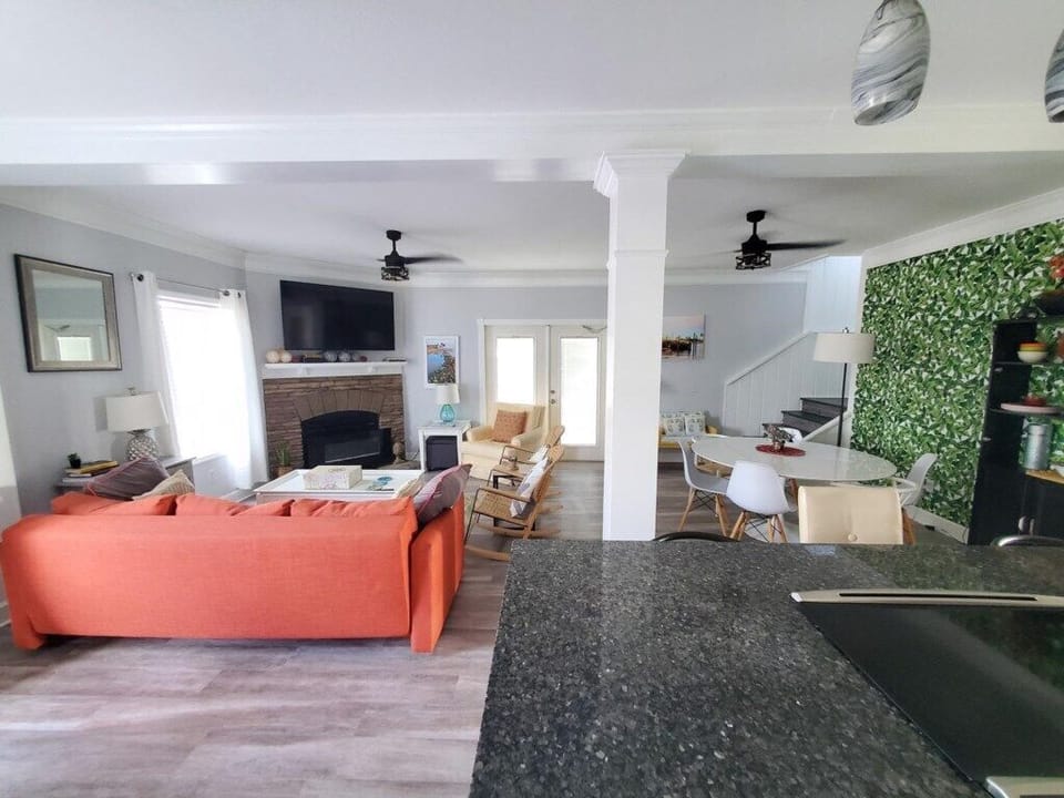 Open-plan living space with cozy lounge area and bright dining nook.