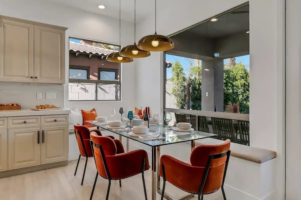 Enjoy morning coffee or intimate dinners in this stylish nook framed by large windows and contemporary lighting.