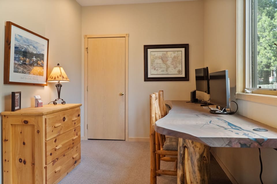 Bedroom 1: Twin bed, dedicated workspace, main floor